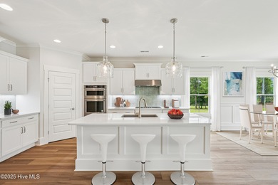 Discover the Skiff, a beautiful new Logan Home, located in on Sea Trail Golf Resort in North Carolina - for sale on GolfHomes.com, golf home, golf lot