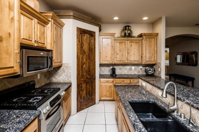 Take a look at this stunning RV garage home located in a private on London Bridge Golf Course in Arizona - for sale on GolfHomes.com, golf home, golf lot