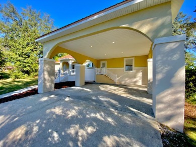 Elegant Arched views of Dogwood Lake presents both peace and on Dogwood Lakes Golf Club in Florida - for sale on GolfHomes.com, golf home, golf lot