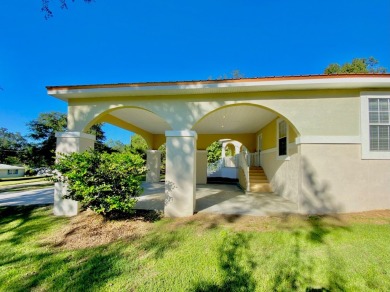 Elegant Arched views of Dogwood Lake presents both peace and on Dogwood Lakes Golf Club in Florida - for sale on GolfHomes.com, golf home, golf lot