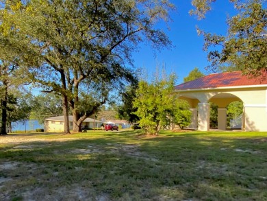 Elegant Arched views of Dogwood Lake presents both peace and on Dogwood Lakes Golf Club in Florida - for sale on GolfHomes.com, golf home, golf lot