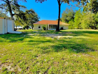 Elegant Arched views of Dogwood Lake presents both peace and on Dogwood Lakes Golf Club in Florida - for sale on GolfHomes.com, golf home, golf lot