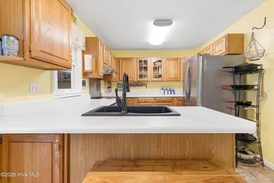 Canalfront 4-bedroom home situated on a private lot in Pine on The Country Club of the Crystal Coast in North Carolina - for sale on GolfHomes.com, golf home, golf lot