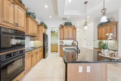 Immaculate Bonaire model with custom free form pool, amazing lot on Pelican Pointe Golf and Country Club in Florida - for sale on GolfHomes.com, golf home, golf lot
