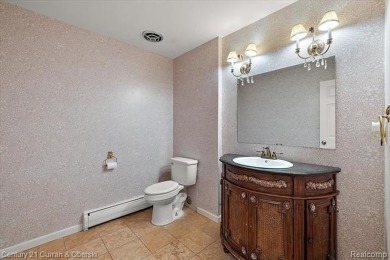 Tucked away on a wooded lot that directly backs up to McClumpha on Hilltop Golf Course in Michigan - for sale on GolfHomes.com, golf home, golf lot