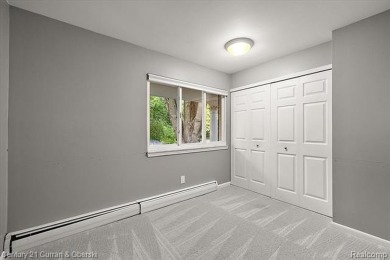 Tucked away on a wooded lot that directly backs up to McClumpha on Hilltop Golf Course in Michigan - for sale on GolfHomes.com, golf home, golf lot