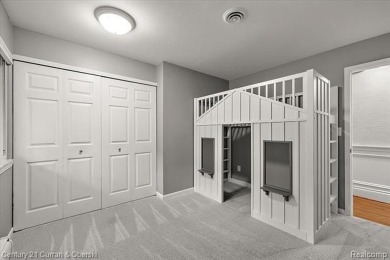Tucked away on a wooded lot that directly backs up to McClumpha on Hilltop Golf Course in Michigan - for sale on GolfHomes.com, golf home, golf lot
