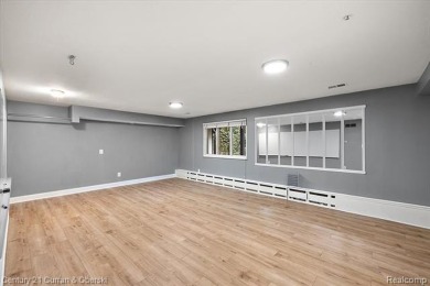 Tucked away on a wooded lot that directly backs up to McClumpha on Hilltop Golf Course in Michigan - for sale on GolfHomes.com, golf home, golf lot