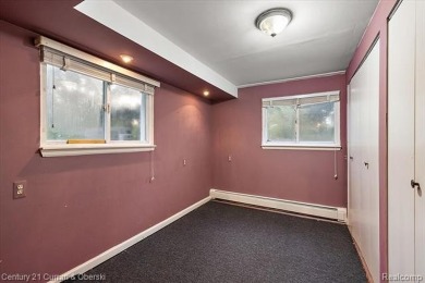 Tucked away on a wooded lot that directly backs up to McClumpha on Hilltop Golf Course in Michigan - for sale on GolfHomes.com, golf home, golf lot