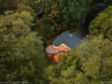 Tucked away on a wooded lot that directly backs up to McClumpha on Hilltop Golf Course in Michigan - for sale on GolfHomes.com, golf home, golf lot