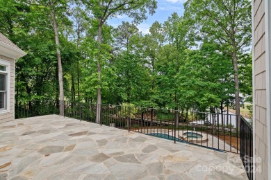 Indulge in serenity on 1.32 acres with lake/golf course views on Trump National Golf Club Charlotte in North Carolina - for sale on GolfHomes.com, golf home, golf lot