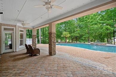 Indulge in serenity on 1.32 acres with lake/golf course views on Trump National Golf Club Charlotte in North Carolina - for sale on GolfHomes.com, golf home, golf lot