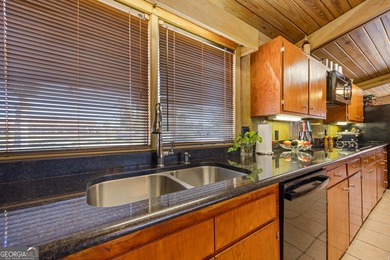 Discover this beautifully preserved mid-century lake house on Francis Lake Golf Club in Georgia - for sale on GolfHomes.com, golf home, golf lot