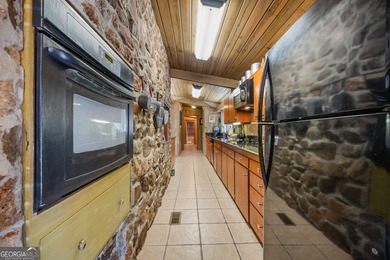 Discover this beautifully preserved mid-century lake house on Francis Lake Golf Club in Georgia - for sale on GolfHomes.com, golf home, golf lot