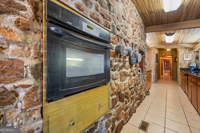 Discover this beautifully preserved mid-century lake house on Francis Lake Golf Club in Georgia - for sale on GolfHomes.com, golf home, golf lot