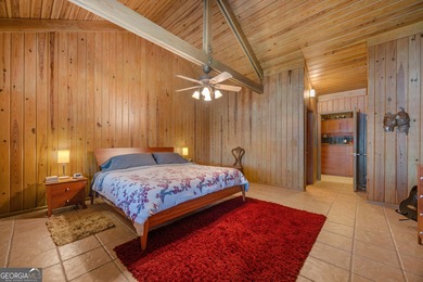 Discover this beautifully preserved mid-century lake house on Francis Lake Golf Club in Georgia - for sale on GolfHomes.com, golf home, golf lot