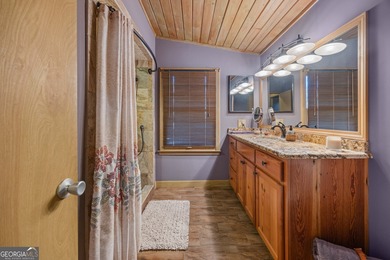 Discover this beautifully preserved mid-century lake house on Francis Lake Golf Club in Georgia - for sale on GolfHomes.com, golf home, golf lot