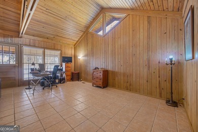 Discover this beautifully preserved mid-century lake house on Francis Lake Golf Club in Georgia - for sale on GolfHomes.com, golf home, golf lot