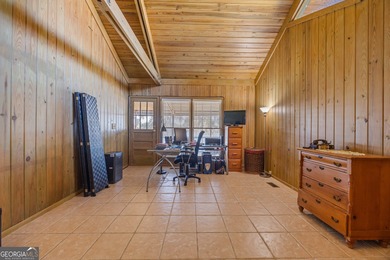 Discover this beautifully preserved mid-century lake house on Francis Lake Golf Club in Georgia - for sale on GolfHomes.com, golf home, golf lot