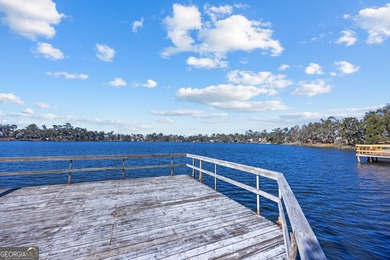 Discover this beautifully preserved mid-century lake house on Francis Lake Golf Club in Georgia - for sale on GolfHomes.com, golf home, golf lot