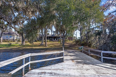 Discover this beautifully preserved mid-century lake house on Francis Lake Golf Club in Georgia - for sale on GolfHomes.com, golf home, golf lot