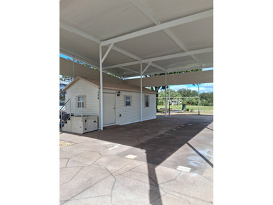 LARGE RV LOT WITH OVERSIZED PORT, BEDROOM, BATH, PATIO AREA AND on Deer Creek RV Golf Resort in Florida - for sale on GolfHomes.com, golf home, golf lot