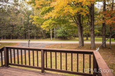 Sitting on a quiet residential street in Hiawatha Township on Indian Lake Golf and Country Club in Michigan - for sale on GolfHomes.com, golf home, golf lot