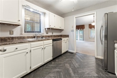 Nestled on the picturesque 10th fairway, this beautiful townhome on Gates Four Golf and Country Club in North Carolina - for sale on GolfHomes.com, golf home, golf lot