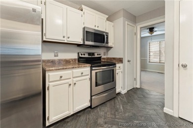 Nestled on the picturesque 10th fairway, this beautiful townhome on Gates Four Golf and Country Club in North Carolina - for sale on GolfHomes.com, golf home, golf lot
