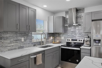 You don't want to miss this stunning, updated corner lot home in on Mangrove Bay Golf Course in Florida - for sale on GolfHomes.com, golf home, golf lot