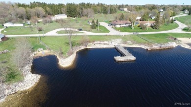 Escape to your own waterfront paradise on Garden Bay! This on Garden Golf Course in Michigan - for sale on GolfHomes.com, golf home, golf lot