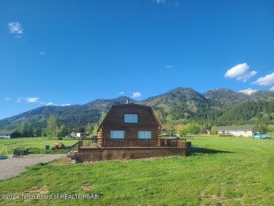 Quaint log cabin living at the base of the Bridger-Teton on Cedar Creek Golf Course in Wyoming - for sale on GolfHomes.com, golf home, golf lot