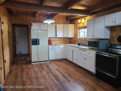 Quaint log cabin living at the base of the Bridger-Teton on Cedar Creek Golf Course in Wyoming - for sale on GolfHomes.com, golf home, golf lot