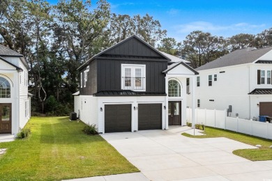 Welcome to this luxurious 4-bedroom, 3.5-bath beach home! on Whispering Pines in South Carolina - for sale on GolfHomes.com, golf home, golf lot