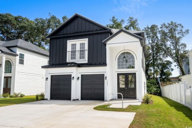 Welcome to this luxurious 4-bedroom, 3.5-bath beach home! on Whispering Pines in South Carolina - for sale on GolfHomes.com, golf home, golf lot