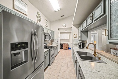 Enjoy beautiful golf course and pond views from this 2-bedroom on Tampa Bay Golf and Country Club in Florida - for sale on GolfHomes.com, golf home, golf lot