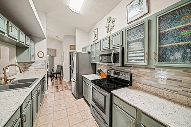 Enjoy beautiful golf course and pond views from this 2-bedroom on Tampa Bay Golf and Country Club in Florida - for sale on GolfHomes.com, golf home, golf lot