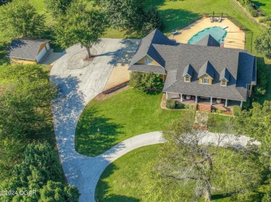 Discover luxurious living in the picturesque community of on Carthage Municipal Golf Course in Missouri - for sale on GolfHomes.com, golf home, golf lot