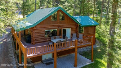 Escape to your own hand-hewn log retreat nestled in the woods of on Cedar Creek Golf Course in Wyoming - for sale on GolfHomes.com, golf home, golf lot