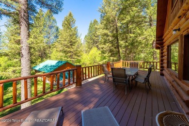 Escape to your own hand-hewn log retreat nestled in the woods of on Cedar Creek Golf Course in Wyoming - for sale on GolfHomes.com, golf home, golf lot