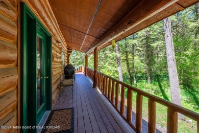 Escape to your own hand-hewn log retreat nestled in the woods of on Cedar Creek Golf Course in Wyoming - for sale on GolfHomes.com, golf home, golf lot