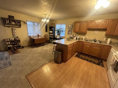 Discover the easy life in Okoboji with this inviting upper-level on Brooks National Golf Club in Iowa - for sale on GolfHomes.com, golf home, golf lot