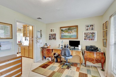 This immaculately maintained Midcentury home is nestled along on Lake Worth Municipal Golf Course in Florida - for sale on GolfHomes.com, golf home, golf lot