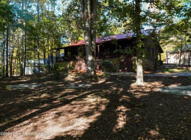 This 3 bedroom, 2 bath one level log home sits on a large flat on Stillwaters Golf and Country Club in Alabama - for sale on GolfHomes.com, golf home, golf lot