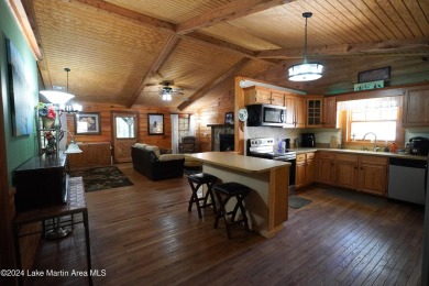 This 3 bedroom, 2 bath one level log home sits on a large flat on Stillwaters Golf and Country Club in Alabama - for sale on GolfHomes.com, golf home, golf lot