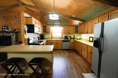 This 3 bedroom, 2 bath one level log home sits on a large flat on Stillwaters Golf and Country Club in Alabama - for sale on GolfHomes.com, golf home, golf lot