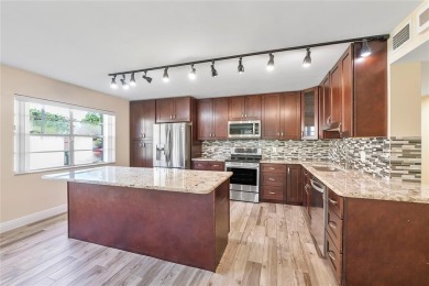 Beautifully renovated 3-bedroom, 2-bathroom corner unit in Holly on Woodmont Country Club in Florida - for sale on GolfHomes.com, golf home, golf lot
