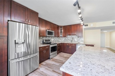 Beautifully renovated 3-bedroom, 2-bathroom corner unit in Holly on Woodmont Country Club in Florida - for sale on GolfHomes.com, golf home, golf lot