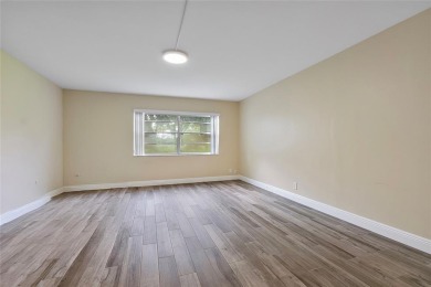 Beautifully renovated 3-bedroom, 2-bathroom corner unit in Holly on Woodmont Country Club in Florida - for sale on GolfHomes.com, golf home, golf lot