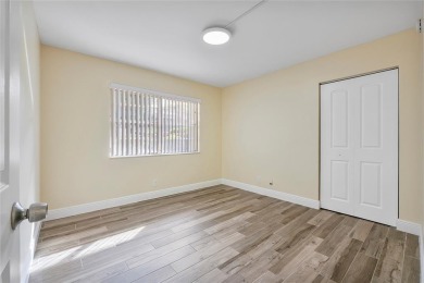 Beautifully renovated 3-bedroom, 2-bathroom corner unit in Holly on Woodmont Country Club in Florida - for sale on GolfHomes.com, golf home, golf lot